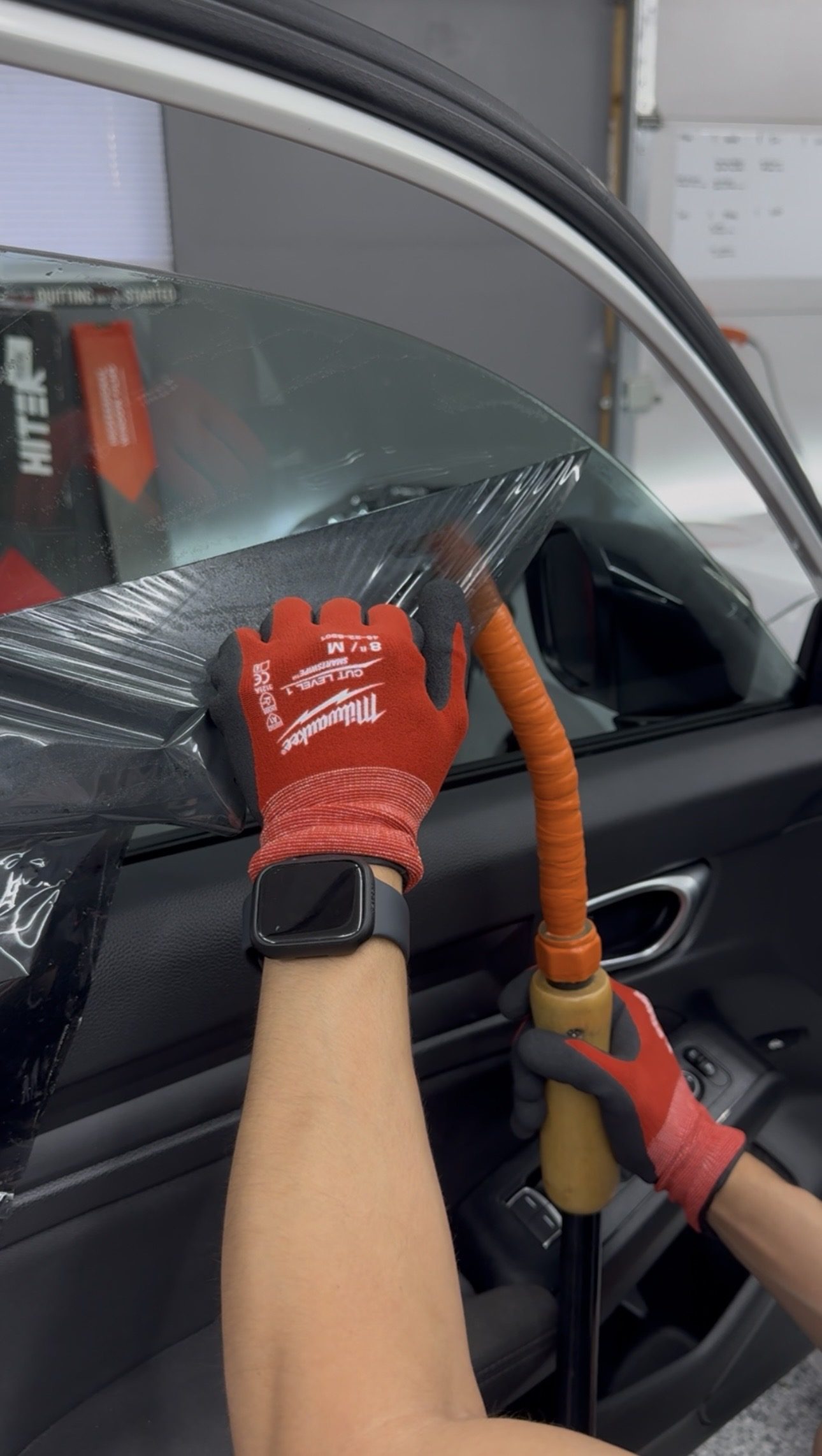 Tint removal in progress with steam