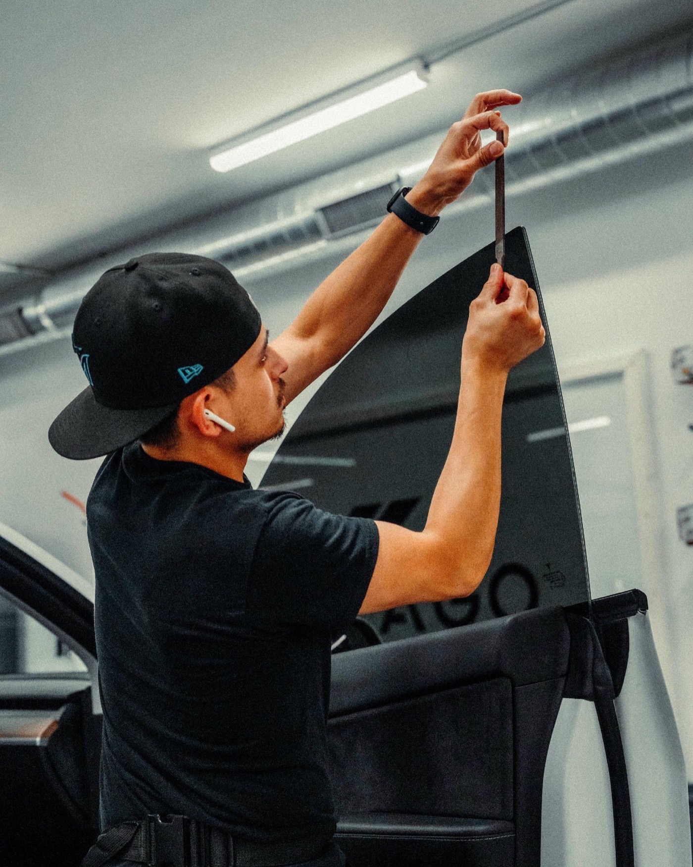 Technician measuring automotive window film